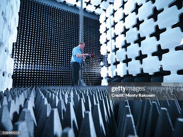 engineer in anechoic chamber with horn antenna set up for electromagnetic compatibility (emc) radiated emission testing - central scotland 個照片及圖片檔