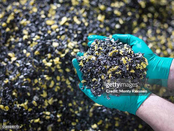 worker holding recycled plastic in plastics factory, close up - plastic stock pictures, royalty-free photos & images