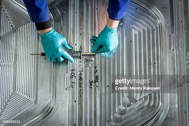 overhead view of worker finishing metal mould in plastics factory, close up - gray glove stock pictures, royalty-free photos & images