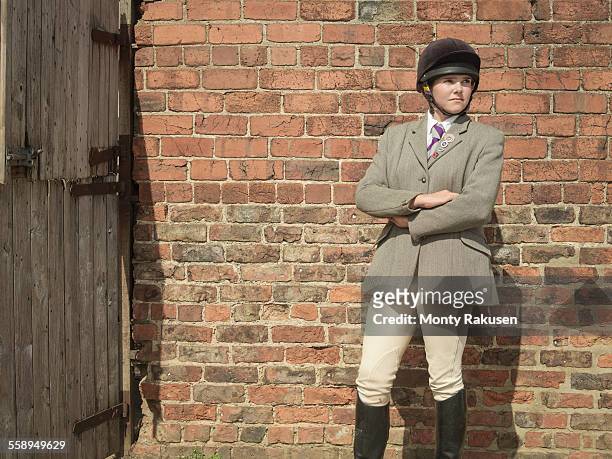 farmers daughter in riding clothes, looking away - 乗馬帽 ストックフォトと画像