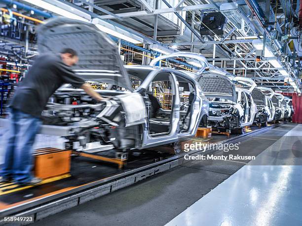 Worker on car production line in car factory