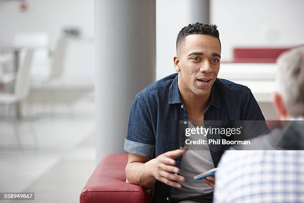 businessmen meeting on office sofas - concept updates stockfoto's en -beelden