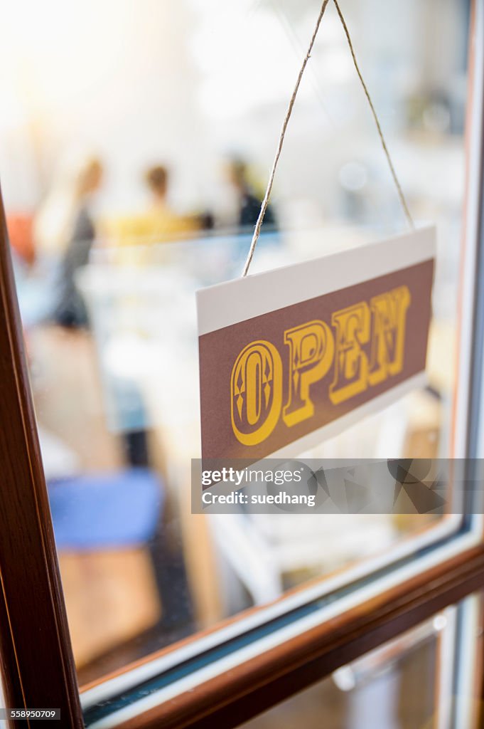 Open sign on cafe door, close-up