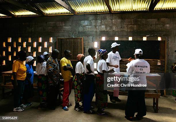 Liberians line to up to pick up blank ballots and vote on election day October 11, 2005 in Monrovia, Liberia. Liberia, beset by 13 years of savage...