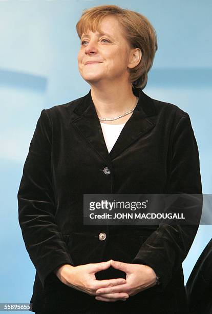 Christian Democratic Union leader Angela Merkel stands on a stage during an election rally in Dresden 30 September 2005, ahead of delayed voting in...