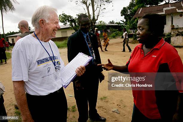 Former U.S. President Jimmy Carter talks with a Liberian woman thanking him for coming October 11, 2005 in Monrovia, Liberia. The Carter Center,...