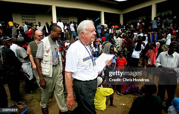 Former U.S. President Jimmy Carter exits a polling site October 11, 2005 in Monrovia, Liberia. The Carter Center, founded by Carter to promote peace...