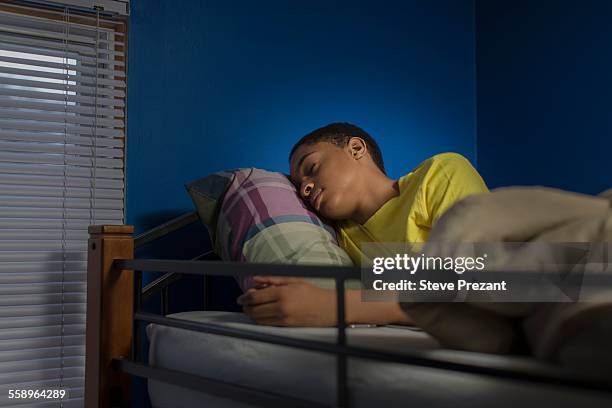 teenage boy asleep in bunkbed - teen sleeping bedroom stock pictures, royalty-free photos & images