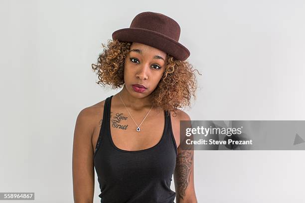 studio portrait of young woman wearing felt hat - name tattoos stock pictures, royalty-free photos & images