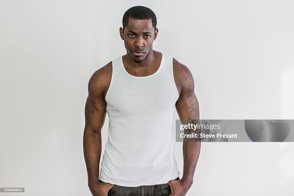 Studio portrait of muscular macho mid adult man