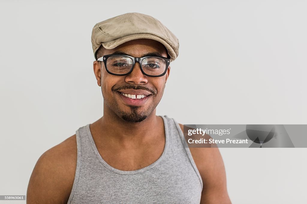 Studio portrait of mid adult man wearing flat cap