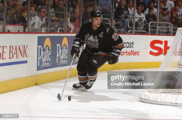 Defenseman Brendan Witt of the Washington Capitals plays the puck behind the net against the Columbus Blue Jackets during the NHL game on October 5,...