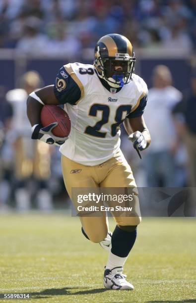 Marshall Faulk of the St. Louis Rams carries the ball during the game against the New York Giants on October 2, 2005 at Giants Stadium in East...