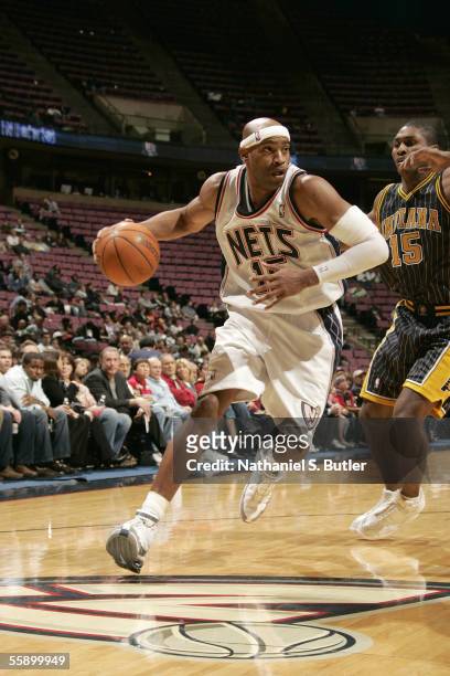 Vince Carter of the New Jersey Nets dribbles against Ron Artest of the Indiana Pacers during the NBA preseason on October 11, 2005 at the Continental...