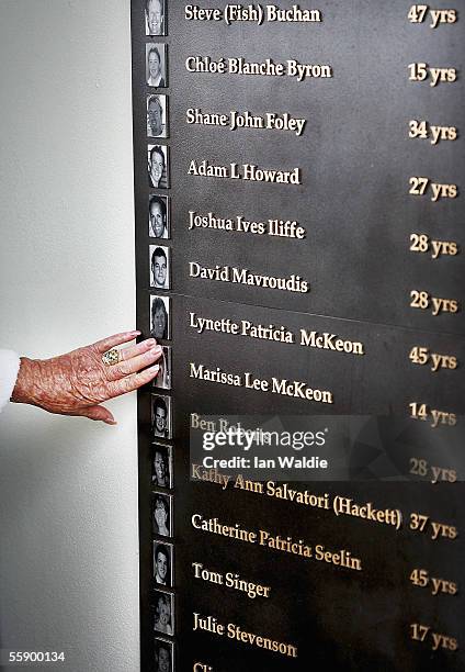 Woman touches the photograph of a relative who died in the 2002 Bali bombs at a memorial on Dolphin Point to commemorate the third anniversary of the...