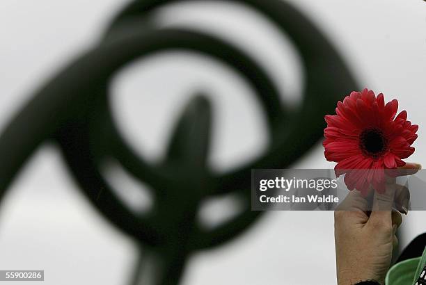 Woman holds a flower as she attends a memorial on Dolphin Point to commemorate the third anniversary of the 2002 Bali bombings October 12, 2005 in...