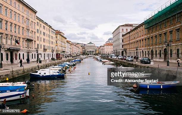 grand canal with boats in trieste, italy - triest stock-fotos und bilder