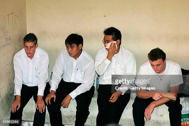 Australians Matthew Norman 19, Thanh Duc Nguyen 22, Si Yi Chen 20, and Martin Stephens 29, sit in the holding cell at the Denpasar District Court for...