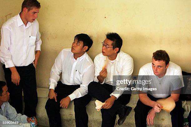 Australians Matthew Norman 19, Thanh Duc Nguyen 22, Si Yi Chen 20, and Martin Stephens 29 wait in the holding cell at the Denpasar District Court for...