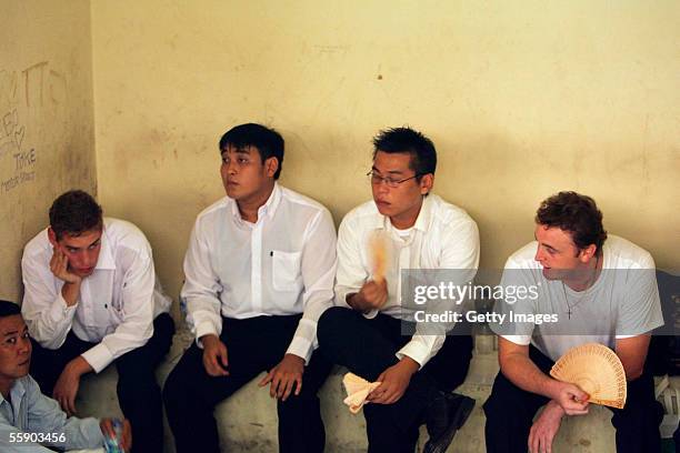 Australians Matthew Norman 19, Thanh Duc Nguyen 22, Si Yi Chen 20, and Martin Stephens 29 wait in the holding cell at the Denpasar District Court for...