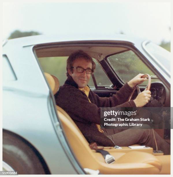 British comic actor Peter Sellers at the wheel of his Ferrari 275 GTB, circa 1965.