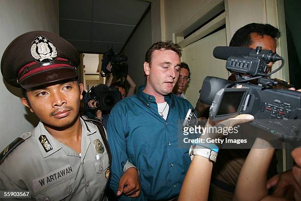 Australian Martin Stephens is escorted to his appearance in Denpasar District Court at the beginning of his trial on October 12, 2005 in Denpasar,...