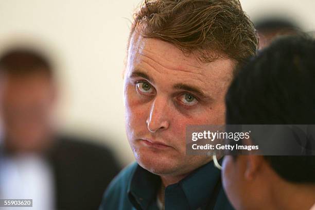 Australian Martin Stephens sits with his Indonesian translator in the Denpasar District Court for the beginning of his trials on October 12, 2005 in...