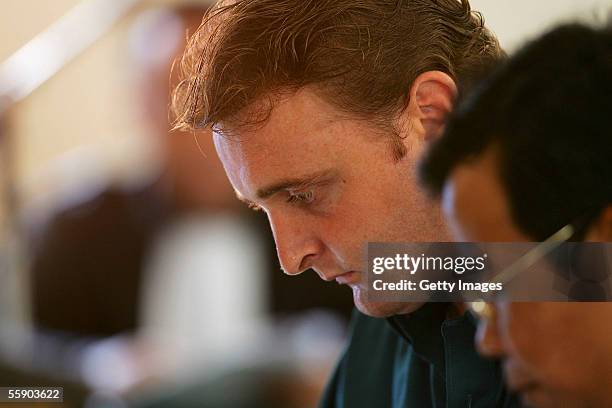 Australian Martin Stephens sits with his Indonesian translator in the Denpasar District Court for the beginning of his trials on October 12, 2005 in...