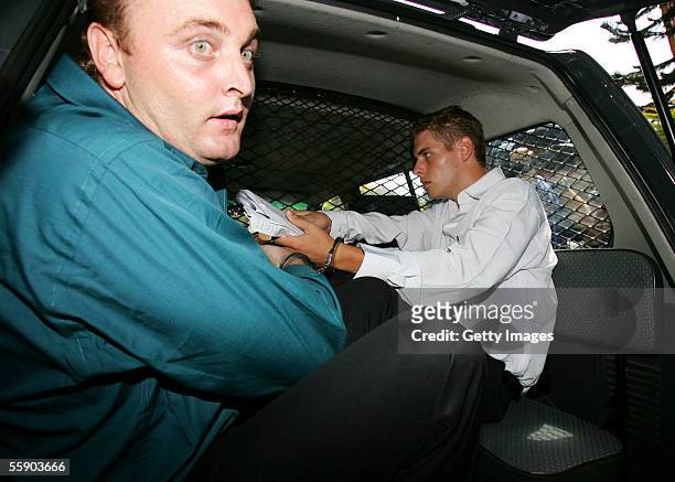 Australians Martin Stephens and Matthew Norman leave Denpasar District Court at the beginning of their trial on October 12, 2005 in Denpasar,...