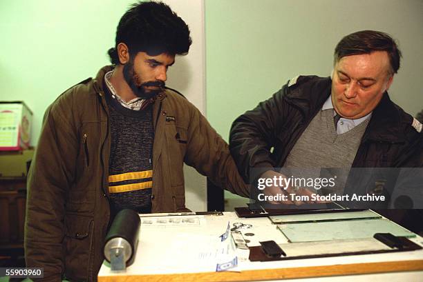 Sri-Lankan illegal immigrant in finger printed at Siegendorf, Austria, after being arrested crossing the border.