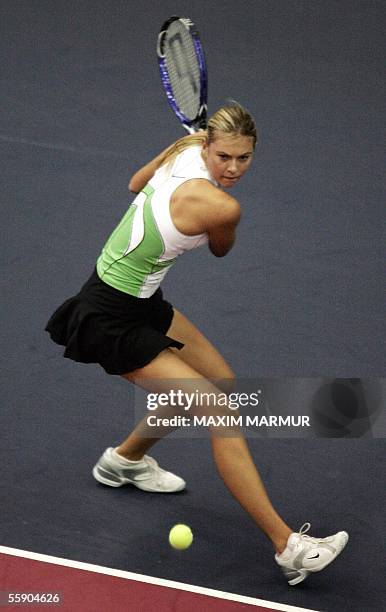 Moscow, RUSSIAN FEDERATION: World's No.1 Russian Maria Sharapova returns a ball to German Anna-Lena Groenefeld during their Kremlin Cup tennis...