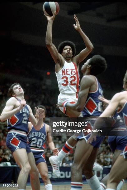 Julius Erving of the American Basketball Association New York Nets takes a shot against the Denver Nuggets during a game at Nassau Coliseum in March...