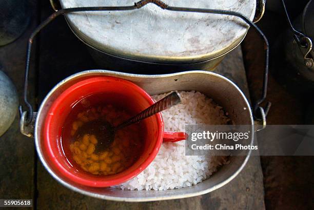 Helping of rice and boiled soybeans for students lunch are seen at a country primary school on October 10, 2005 in Baise, a mountainous area of...