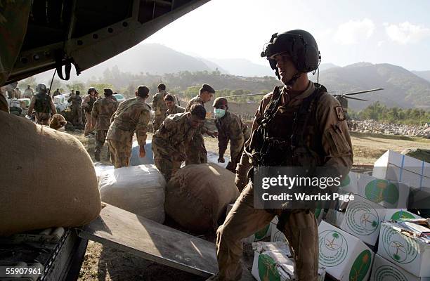 Army soldier unloads relief aid from a helicopter October 12, 2005 in Balakot, Pakistan. Over 30,000 people are believed to have died in the 7.6...