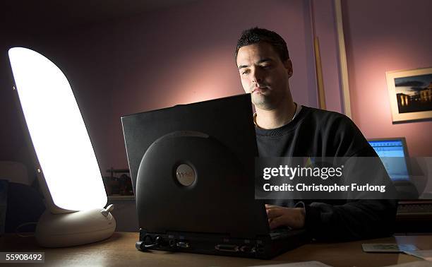 Man suffering from Seasonal Affective Disorder uses a light box in his office to combat the illness on October 12 2005 Glasgow, Scotland. Seasonal...