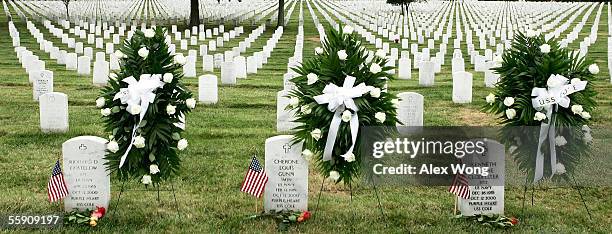 Wreaths are laid next to the tombstones of three victims of the USS Cole attack, Richard Costelow of Johnstown, Pennsylvania; Cherone Gunn of...