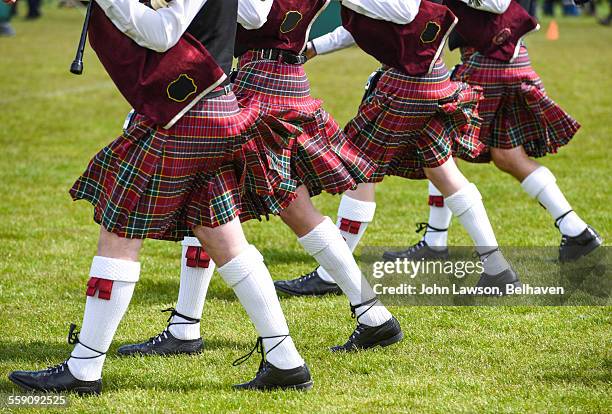 bagpiper's kilts being blown by the wind - piper stock pictures, royalty-free photos & images