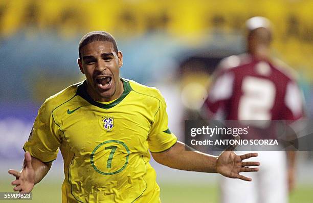 Brazilian Ronaldinho Gaucho jumps over his teammates to celebrate