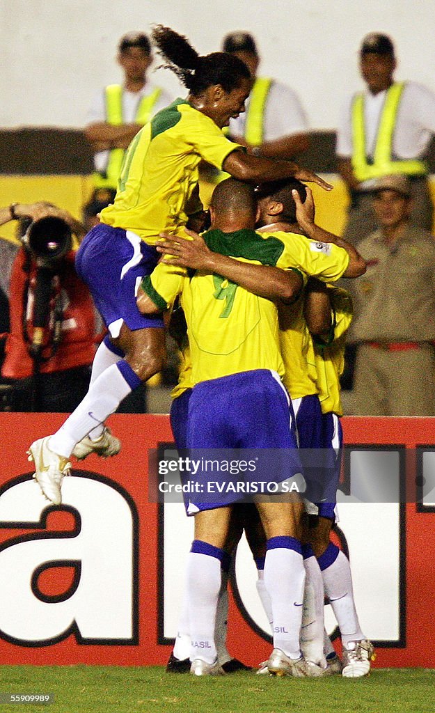 Brazilian Ronaldinho Gaucho jumps over his teammates to celebrate