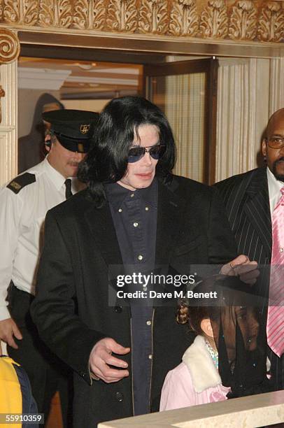 Singer Michael Jackson walks with his daughter, Paris, as they visit Harrods October 12, 2005 in London, England.