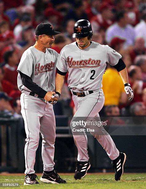 Chris Burke of the Houston Astros is congratulated by third-base coach Doug Mansolino after hitting a pinch-hit two-run home run in the seventh...