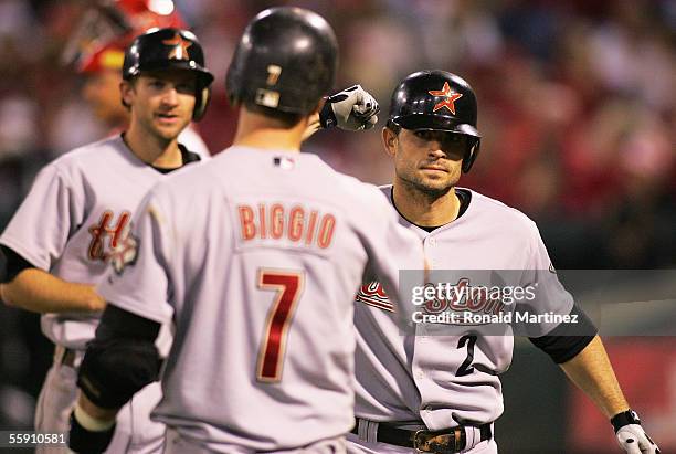 Chris Burke of the Houston Astros is congratulated by Craig Biggio and Adam Everett after Burke hit a pinch-hit two-run home run in the seventh...