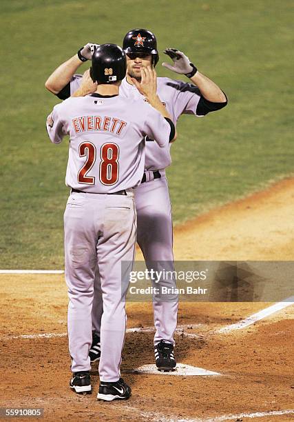Chris Burke of the Houston Astros is congratulated by Adam Everett after Burke hit a pinch-hit two-run home run in the seventh inning against the St....