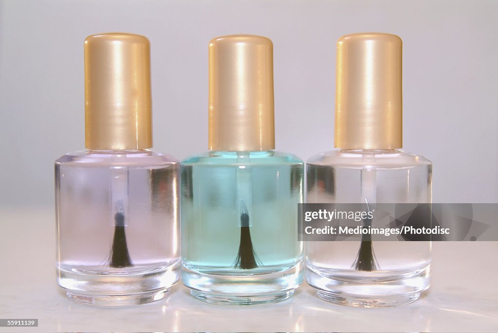 Close-up of three bottles of clear nail polish