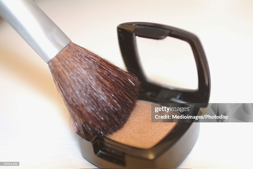 Close-up of a brush on an eyeshadow palette