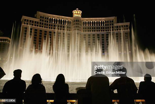 Tourists are silhouetted as they watch the Bellagio fountain show on the Las Vegas Strip October 12, 2005 in Las Vegas, Nevada.