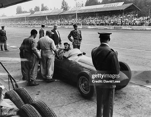 Roberto Mieres of Argentina pulls into the pits to retire the Officine Alfieri Maserati Maserati 250F Maserati Straight-6 during the Italian Grand...