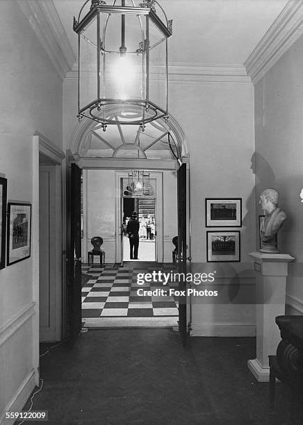 View through the entrance hall of the British Prime Minister's residence at 10 Downing Street, towards the front door, where a policeman stands...