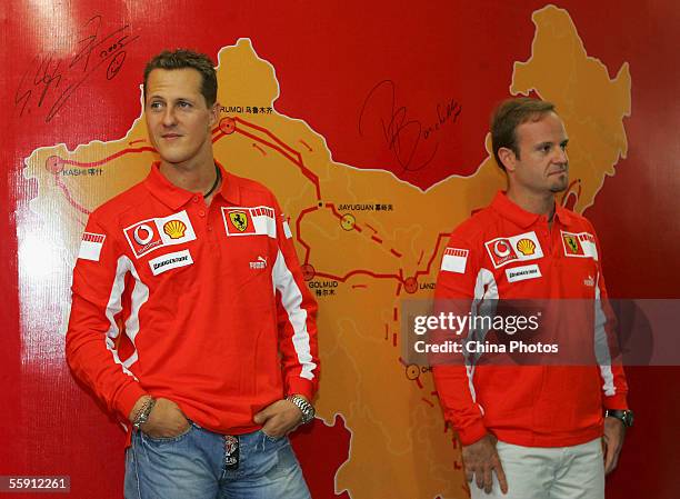 Ferrari F1 team drivers Michael Schumacher and Rubens Barrichello stand in front of China's map during a press conference to promote Ferrari at a...