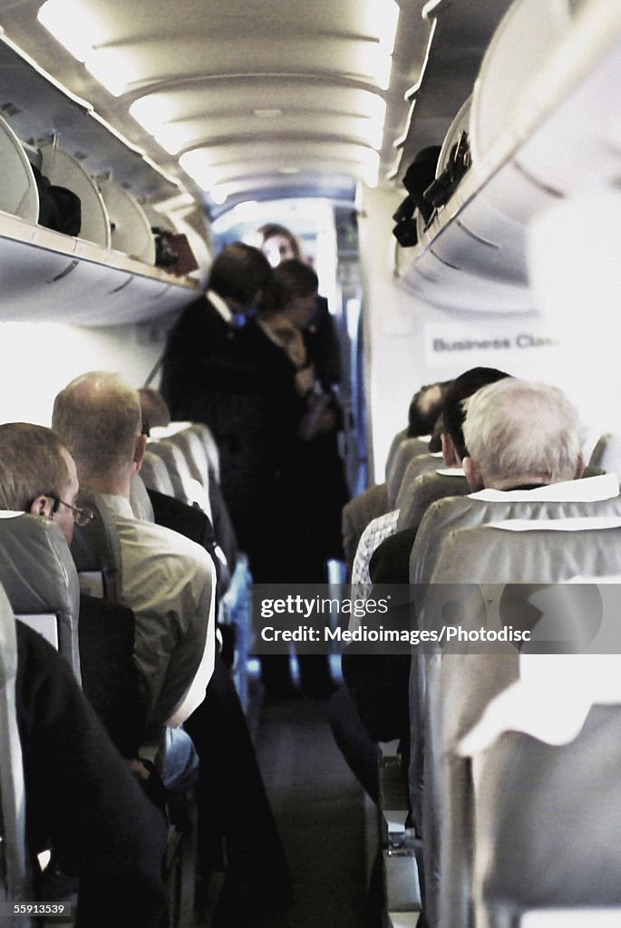 Female airline stewardess serving passengers